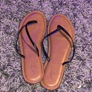 Black and brown flip flops